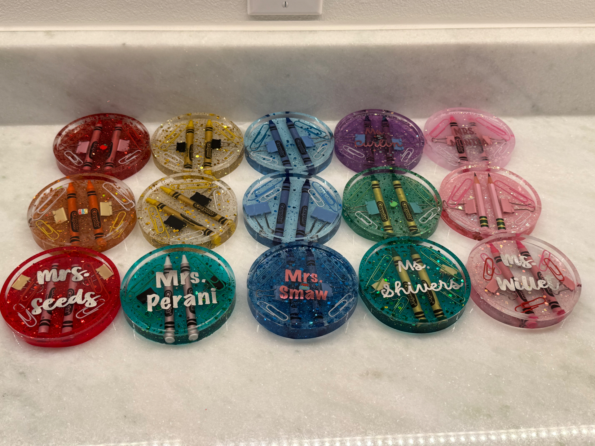 Set of personalized glitter resin coasters with teacher names